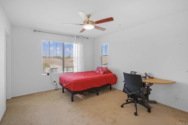 bedroom with light carpet and ceiling fan