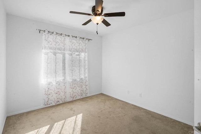 carpeted empty room featuring ceiling fan