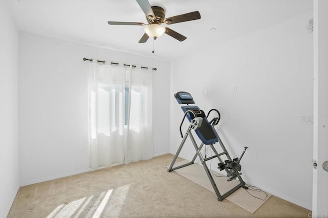 exercise room featuring light colored carpet and ceiling fan