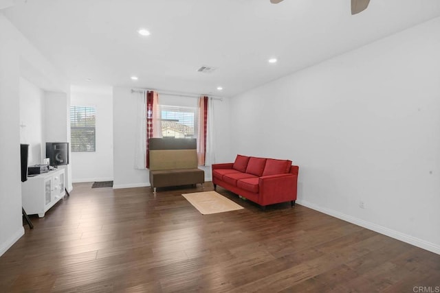 sitting room with ceiling fan and dark hardwood / wood-style flooring