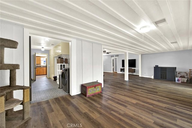 unfurnished living room featuring ceiling fan and dark hardwood / wood-style floors