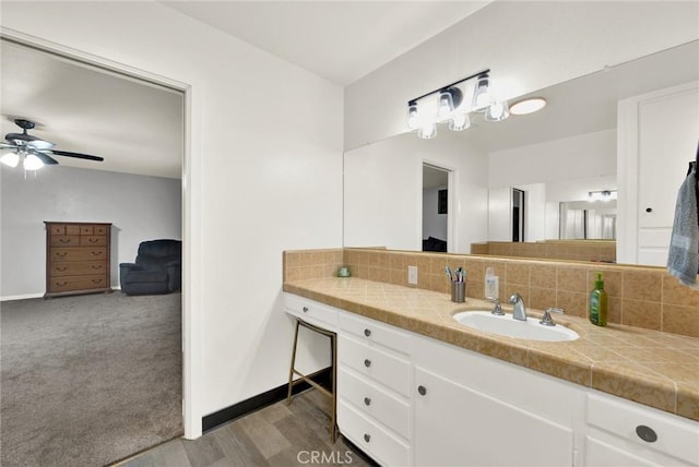 1938 Colusa, Corning, CA 96021 - bathroom featuring decorative backsplash, vanity, ceiling fan, and wood finished floors