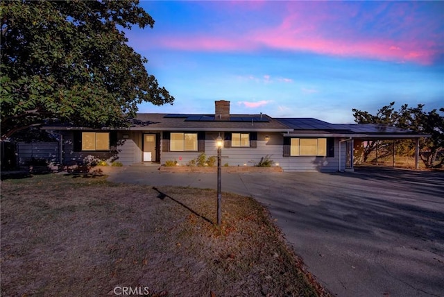 1938 Colusa, Corning, CA 96021 - single story home featuring asphalt driveway, roof mounted solar panels, a carport, and a chimney