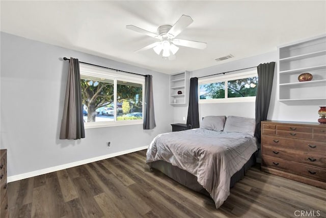 bedroom with ceiling fan and dark wood-type flooring