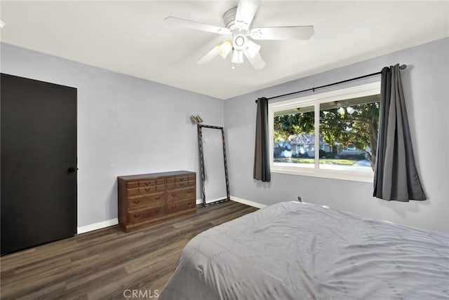 bedroom featuring ceiling fan and dark hardwood / wood-style floors