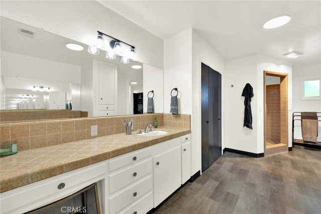 1938 Colusa, Corning, CA 96021 - bathroom featuring wood finished floors, decorative backsplash, and vanity