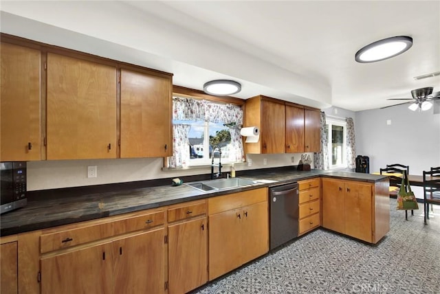 kitchen with kitchen peninsula, appliances with stainless steel finishes, a healthy amount of sunlight, and sink