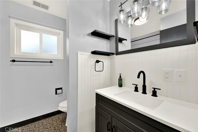 bathroom with vanity and toilet