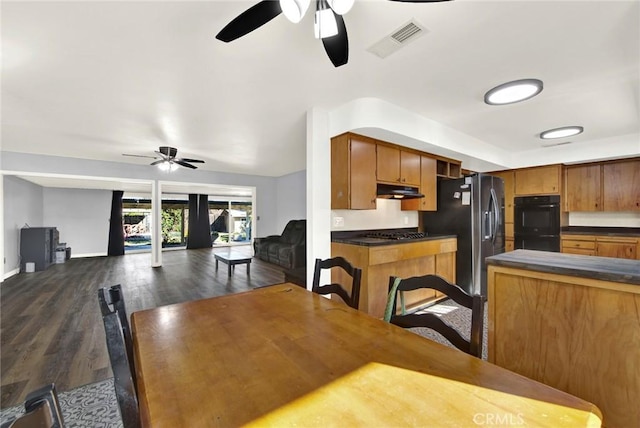 dining area with dark hardwood / wood-style flooring and ceiling fan