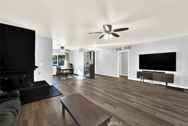 living room with ceiling fan and hardwood / wood-style flooring