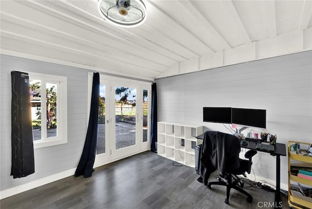 home office featuring dark hardwood / wood-style floors, wood walls, and vaulted ceiling