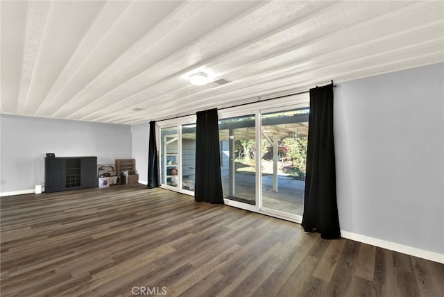 unfurnished living room with dark hardwood / wood-style flooring