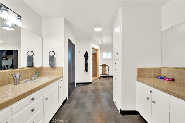 1938 Colusa, Corning, CA 96021 - bathroom featuring backsplash, wood finished floors, and vanity