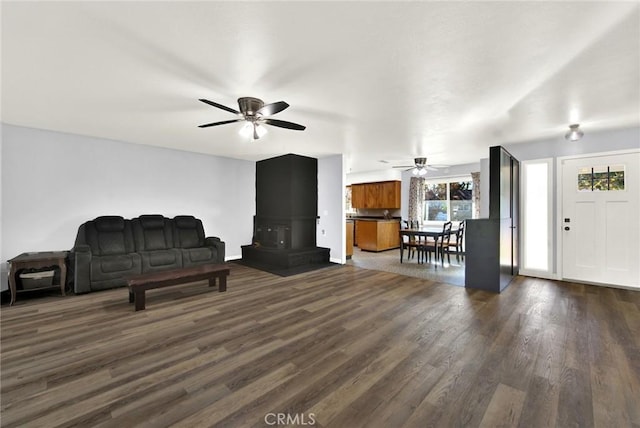 living room with ceiling fan and dark hardwood / wood-style floors