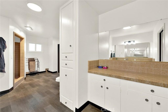1938 Colusa, Corning, CA 96021 - bathroom with wood finished floors, vanity, backsplash, and a shower