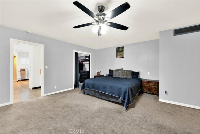 carpeted bedroom featuring a closet, a spacious closet, and ceiling fan