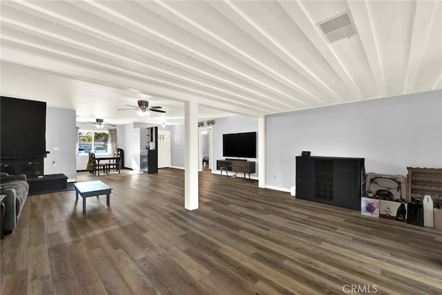 living room with dark hardwood / wood-style flooring and ceiling fan