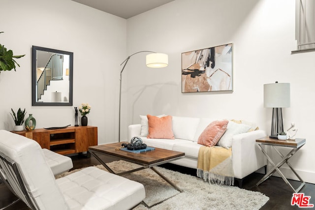 living room with dark hardwood / wood-style flooring