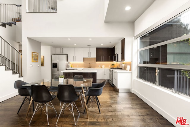 kitchen featuring dark brown cabinetry, white cabinetry, sink, dark wood-type flooring, and stainless steel appliances