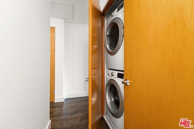 washroom with dark hardwood / wood-style floors and stacked washer and clothes dryer