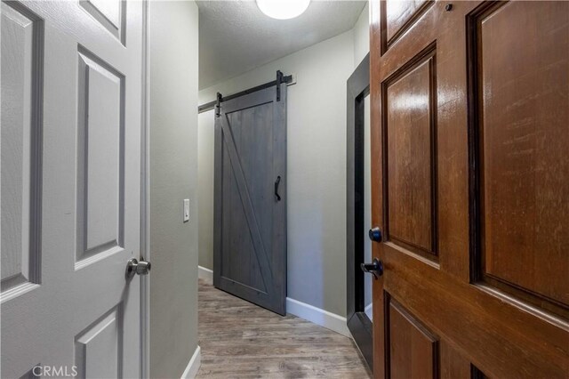 doorway featuring light hardwood / wood-style flooring and a barn door