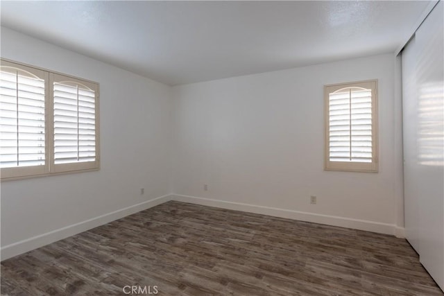 unfurnished room featuring dark hardwood / wood-style flooring