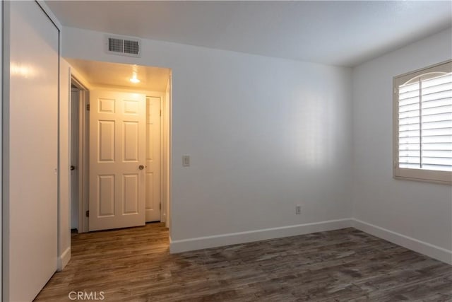 spare room featuring dark hardwood / wood-style floors