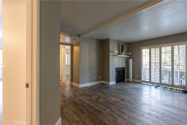 unfurnished living room featuring dark wood-type flooring