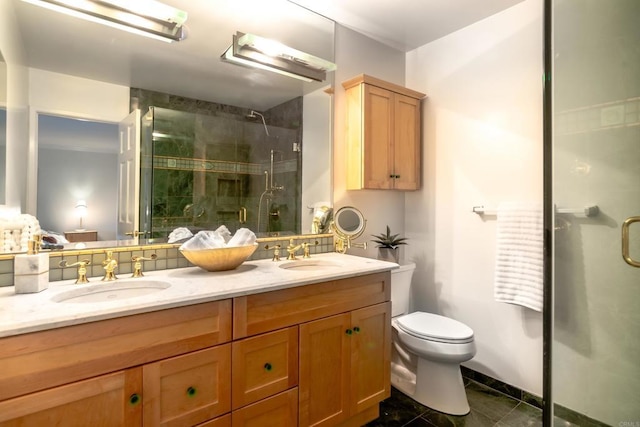 bathroom with tile patterned floors, a shower with door, vanity, and toilet