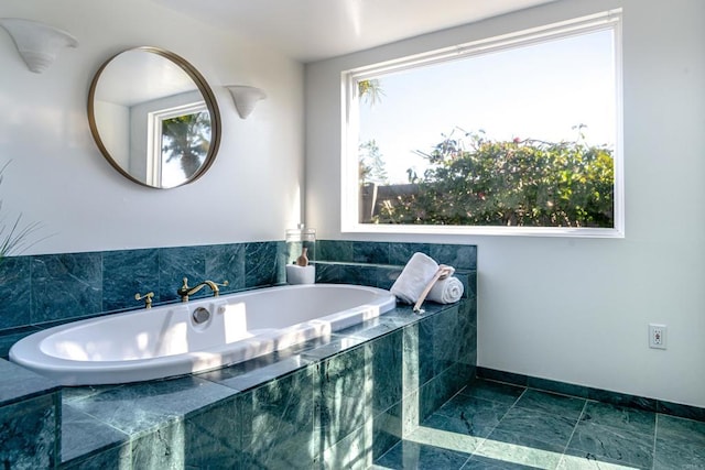 bathroom with tiled bath and plenty of natural light