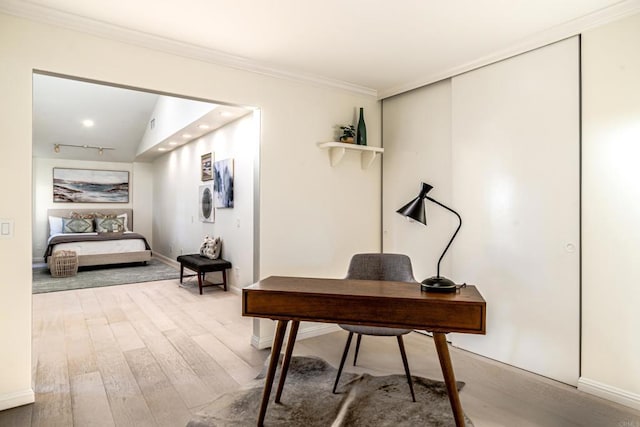 office space featuring crown molding, wood-type flooring, and lofted ceiling