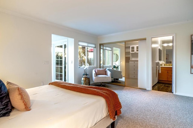 carpeted bedroom with ensuite bathroom and crown molding