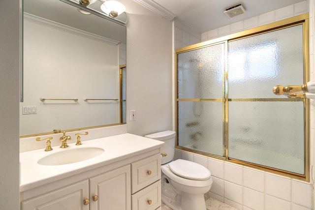 full bathroom with tile patterned floors, vanity, bath / shower combo with glass door, and toilet