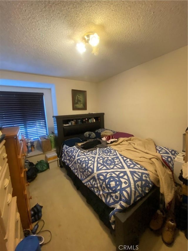 carpeted bedroom featuring a textured ceiling