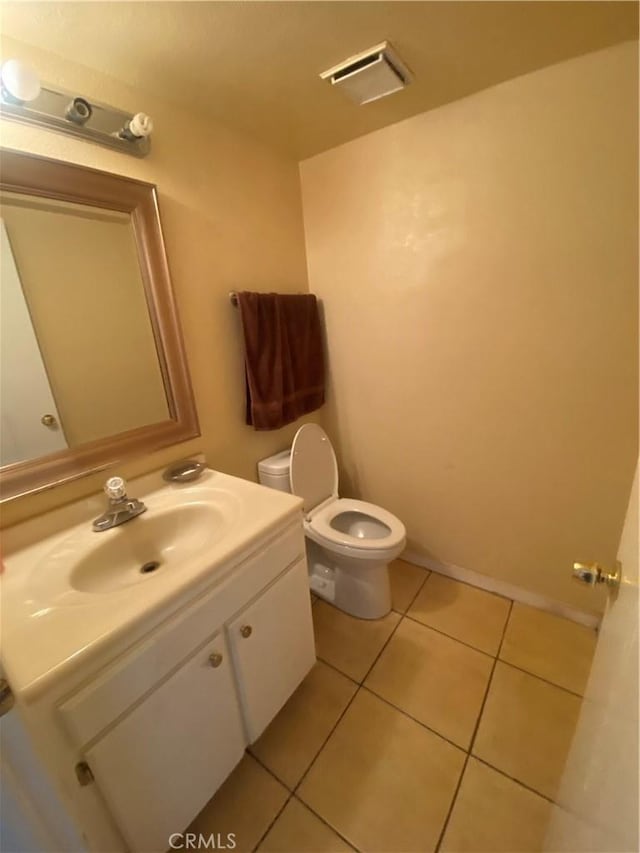 bathroom featuring toilet, vanity, and tile patterned floors