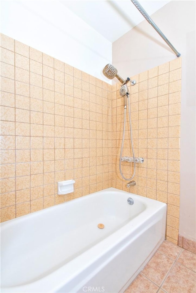 bathroom featuring tile patterned flooring and tiled shower / bath combo