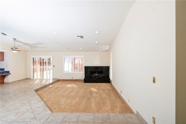 unfurnished living room with ceiling fan and light tile patterned flooring