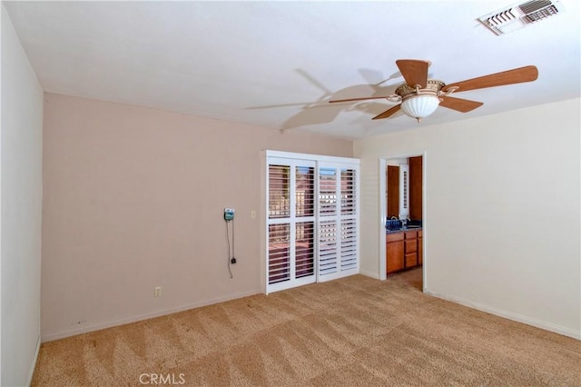 carpeted spare room with ceiling fan