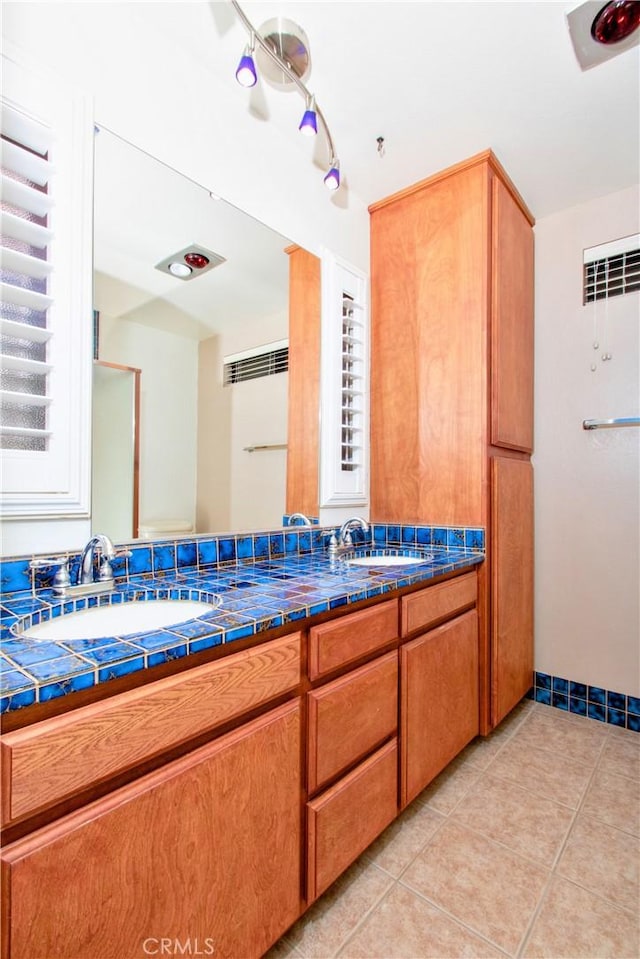 bathroom with tile patterned floors and vanity