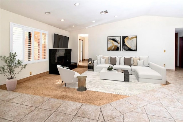 living room with light carpet and vaulted ceiling