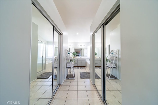 corridor featuring light tile patterned flooring