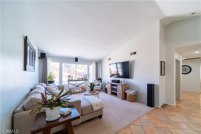 carpeted living room with high vaulted ceiling