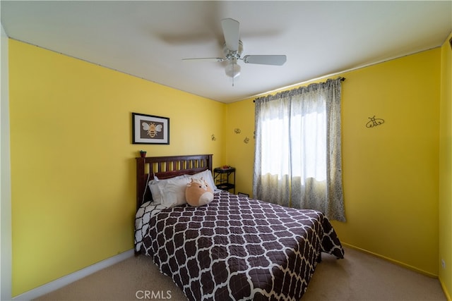 bedroom featuring ceiling fan and light carpet