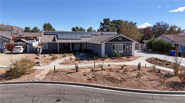 single story home featuring solar panels