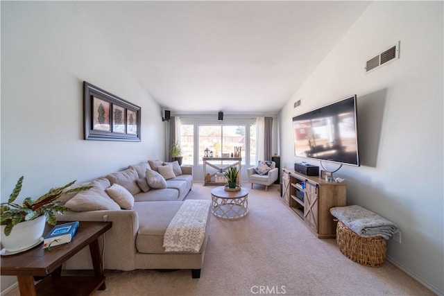 living room with lofted ceiling and carpet floors