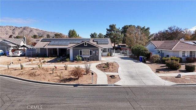 ranch-style house with a mountain view and solar panels