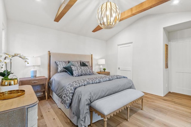 bedroom with light hardwood / wood-style flooring, lofted ceiling with beams, and a chandelier