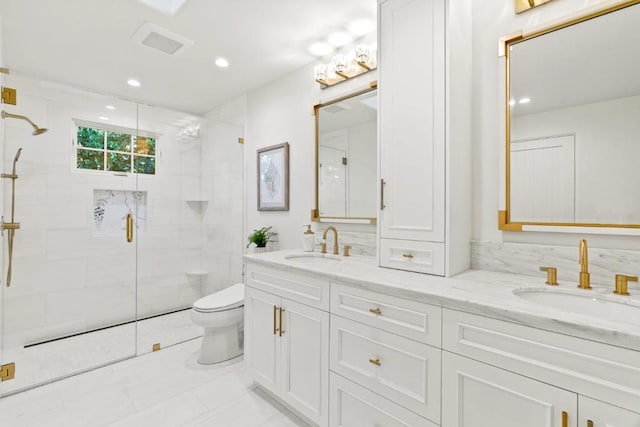 bathroom with a shower with shower door, vanity, and toilet