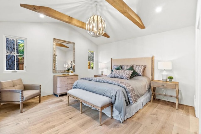 bedroom with an inviting chandelier, light hardwood / wood-style floors, multiple windows, and lofted ceiling with beams