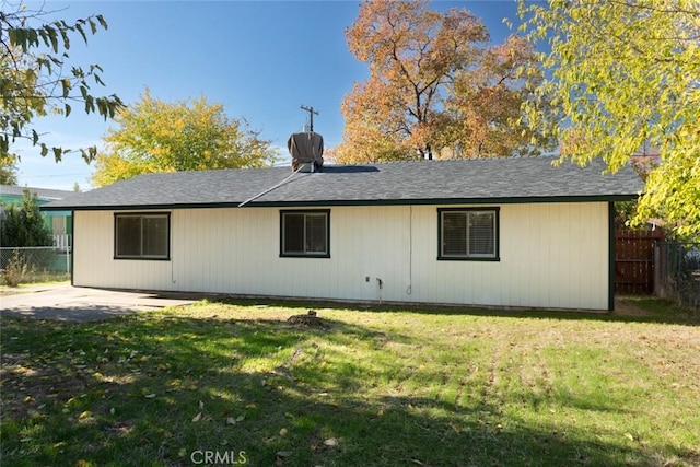 rear view of property featuring a yard